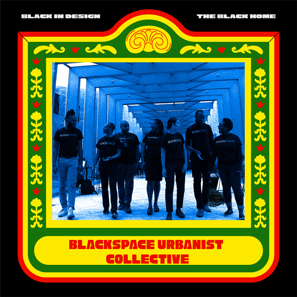 A photograph of a group of seven individuals who are members of the Blackspace Urbanist Collective. They are all standing in a corridor of steel portal frames and are seen as talking to each other. They are all wearing dark colored shirts that have BLACKSPACE printed on them. 